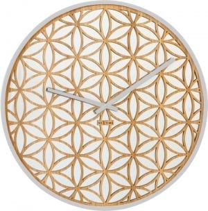 A wooden lattice in a flower pattern over mirrored glass, for a pretty oriental looking wall clock