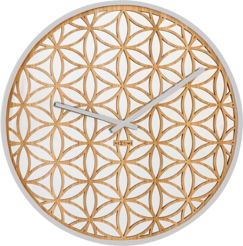 A wooden lattice in a flower pattern over mirrored glass, for a pretty oriental looking wall clock