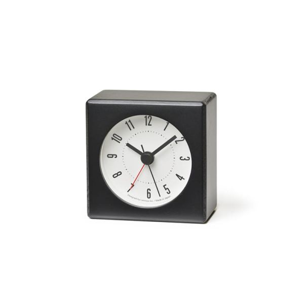 Small alarm clock made from beech, black coloured with a white face. Tiny but powerful.