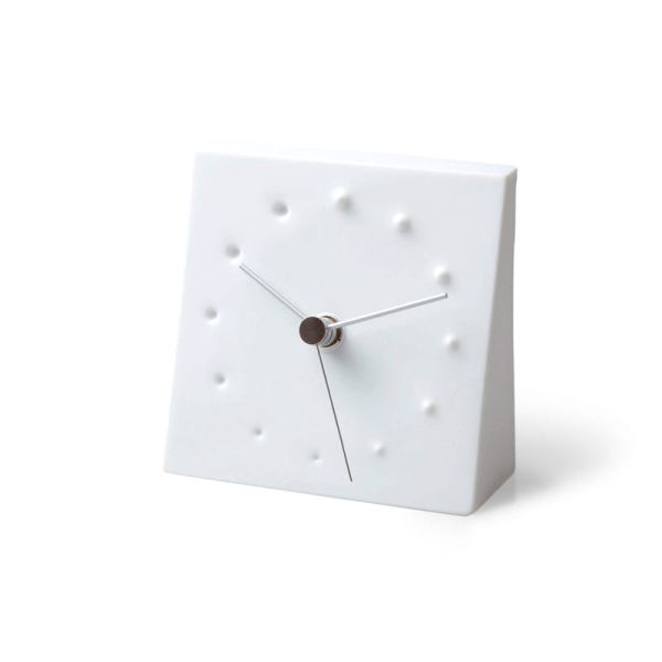 A white porcelain table clock depicting fireworks