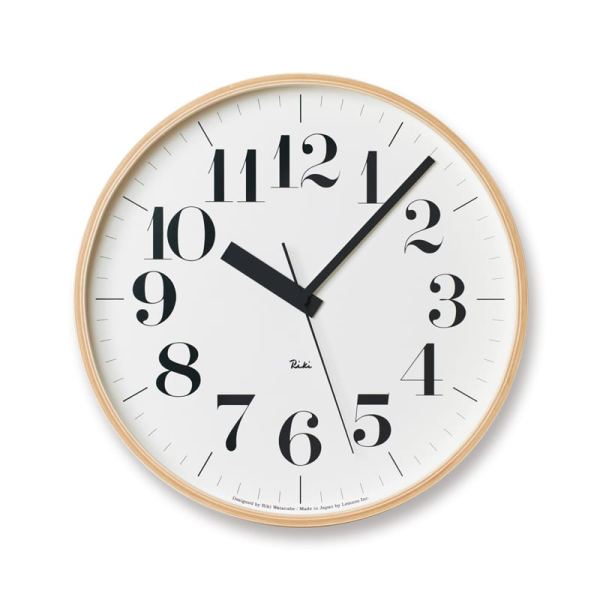 Classsic version of the Riki Clock, with clear easy to read numbers on crisp white, seated within a natural wood frame
