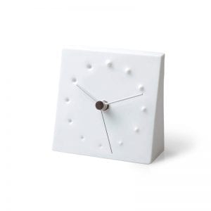 A white porcelain table clock depicting fireworks