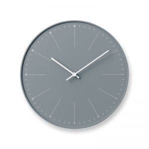 Dandelion heads contrast with the grey face to make a gentle and wistful clock