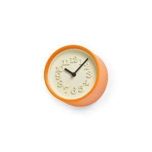 very small, orange framed clock with ivory face and moulded numbers