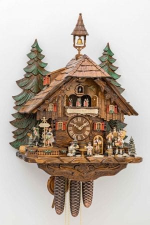 Elaborate and wistfully designed cuckoo clock evoking times past dancer dance to the music of the traditional band.