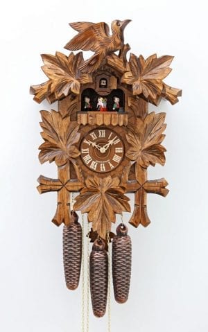 Wooden carved cuckoo and leaves decorate this clock, with dancing pairs to mark the hour to music and a half hourly cuckoo