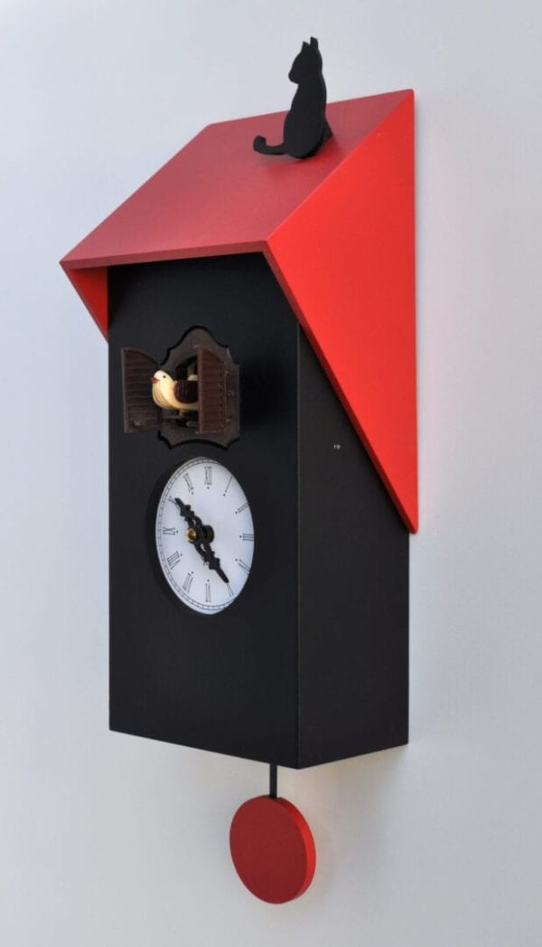 Side view of the black and red cucu vicenza cuckoo clock, showing black clock, red roof and black cat which sits on the roof
