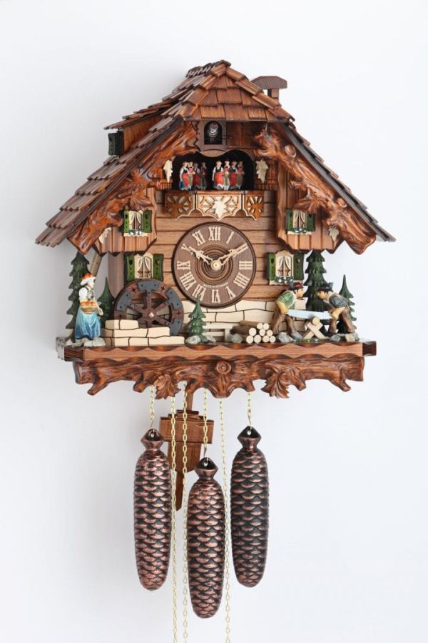 Sawyers and lady in front of bavarian chalet, carved eaves and base