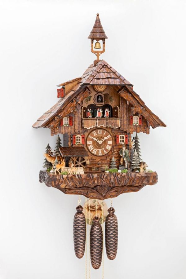 beautifully decorated clock featuring woodland animals and hand carved chalet