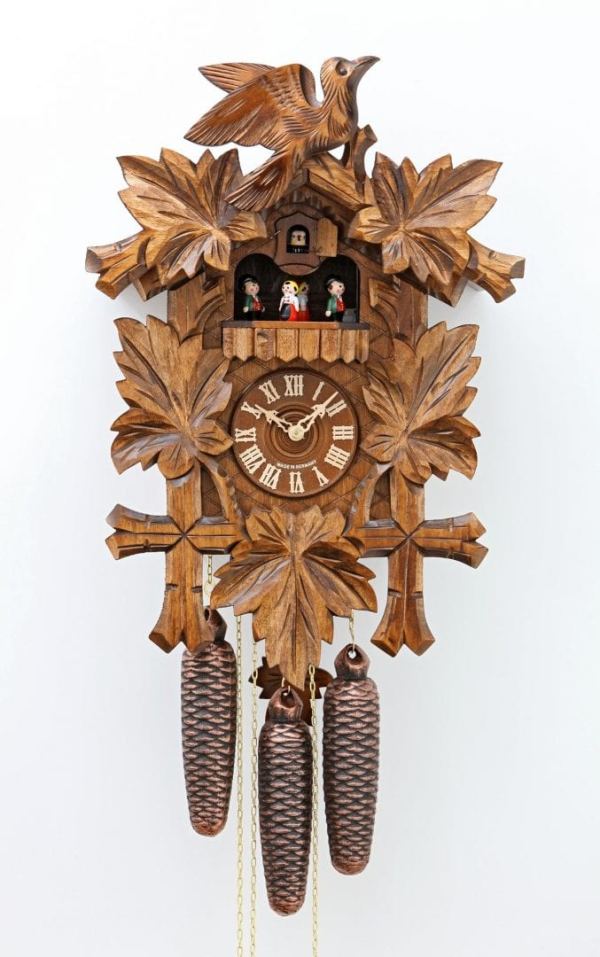 Wooden carved cuckoo and leaves decorate this clock, with dancing pairs to mark the hour to music and a half hourly cuckoo