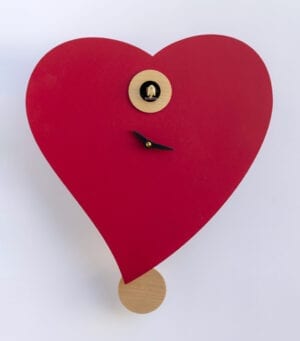 A lovely heart shaped clock with a natural wood pendulum and frame around the cuckoos home. The small hands read the time.