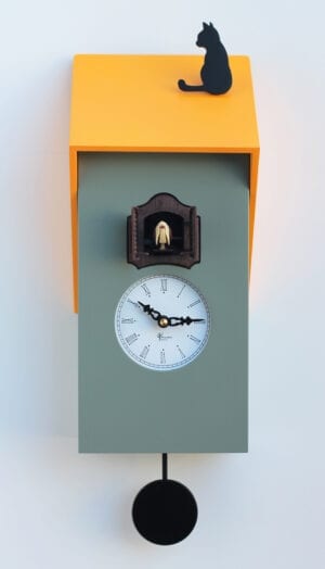 Cucu Vicenza clock in grey and yellow. The mdf clock has a grey body with yellow roof on which sits as black cat. The clock face is white with black numbers and hands and the cuckoo appears above the clock face