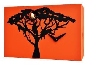 A tree and leopards silhouetted against an orange savannah sky