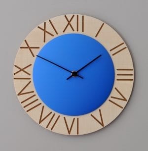 A bright blue disk brings your attention to this clock, which has roman numerals etched into a wooden surround