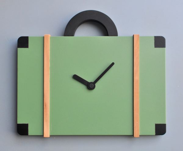 An unusual clock in the form of a bag, in green with pearwood and black detailing