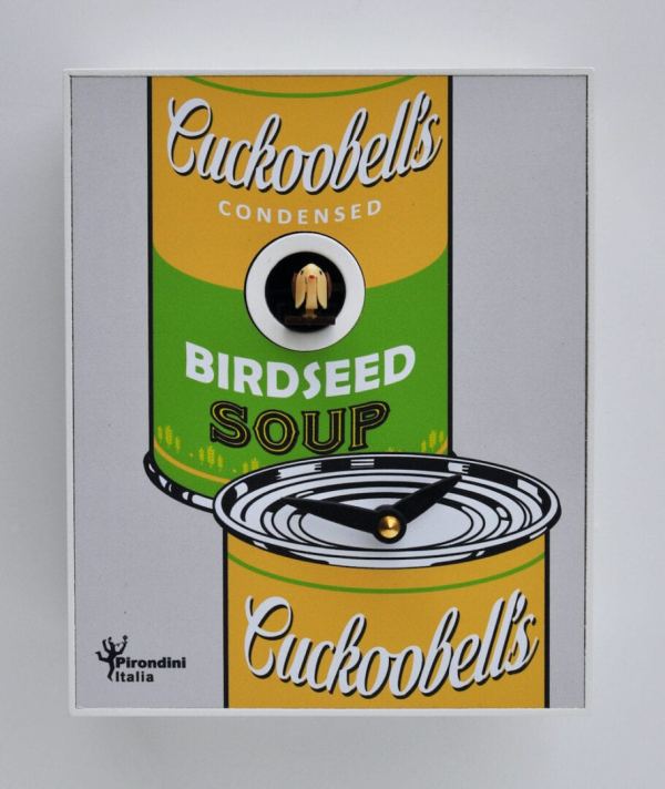 An unusual cuckoo clock designed by Luca Galbusera, in the style of Andy Warhol. The clock has a white background with a Cuckobells Birdseed Soup can in yellow and green. the cuckoo appears from a hole in the soup can.