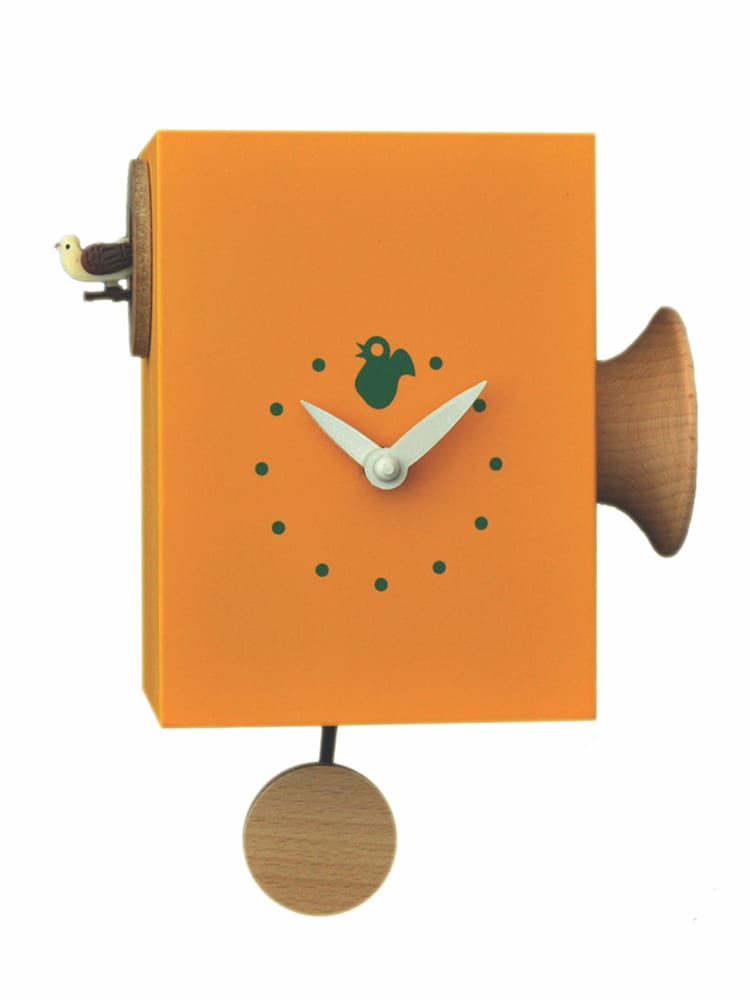 orange clock which has a trumpet to the right and the cuckoo on the left