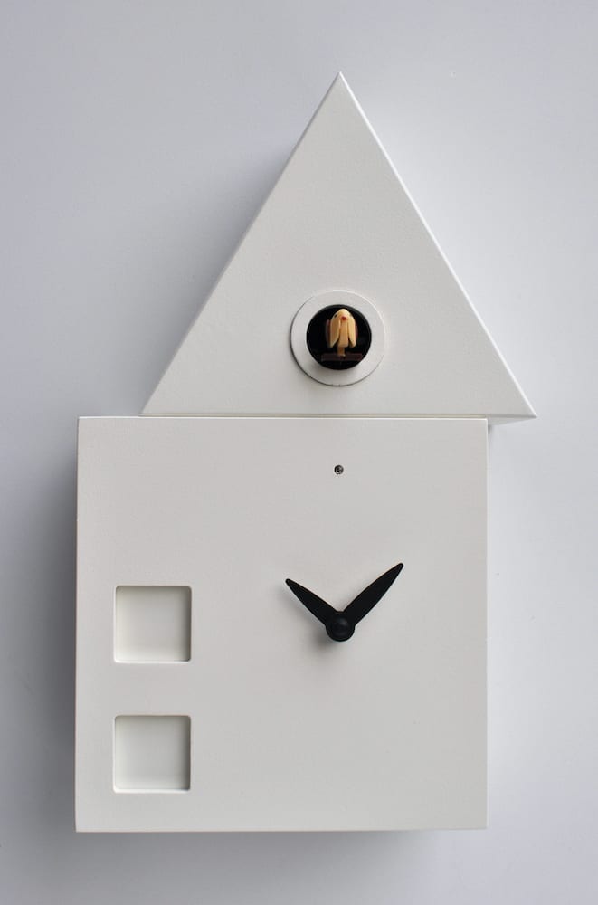 clock in the form of a house with an offset roof housing the cuckoo
