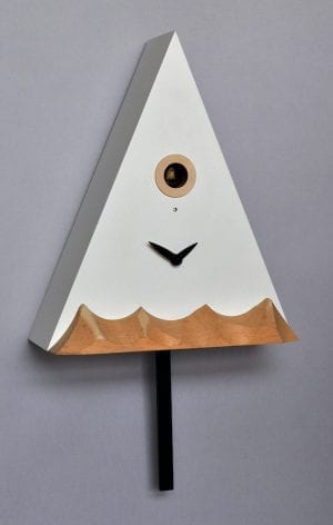 a clock in the form of a mountain peak, with lower mountains carved in natural wood