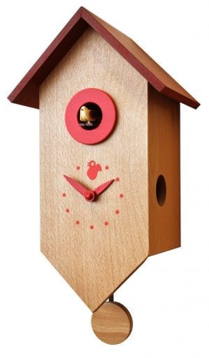 A bird house shaped cuckoo clock in natural wood with red roof and detail