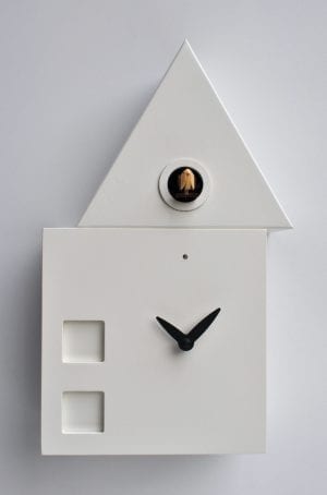 clock in the form of a house with an offset roof housing the cuckoo