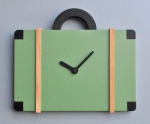 An unusual clock in the form of a bag, in green with pearwood and black detailing