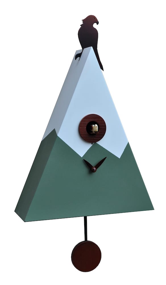 A cuckoo clock in the form of a mountain peak, with an eagle sitting on the summit