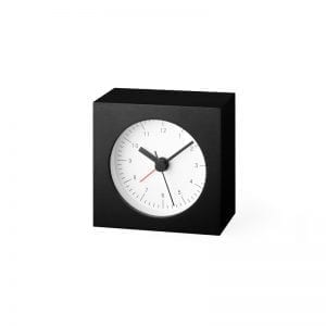 A small square alarm clock with a round face in white, which contrasts well with the black case, the hands and numbers are black