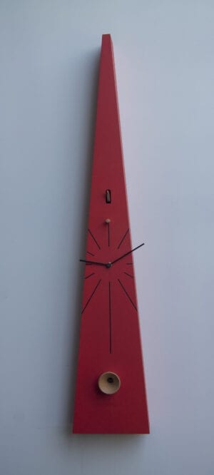 Tall cuckoo clock in red MDF, taking the traditional chalet cuckoo clock and changing it into something very different - long hands reach out past the case of the clock, the the cuckoo peeps from its home at the bottom