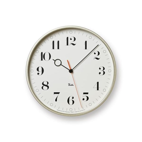 RIKI Ring wall clock in aluminium with white face and a ring hour indicator, representing an eyeglass.