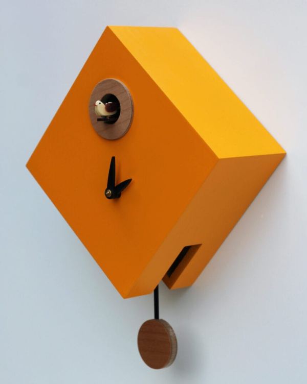 The Rombino Cuckoo Clock in melon yellow, with black hands and cuckoo to the top of the clock
