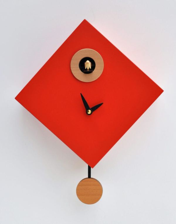 Signal red clock in a diamond shape, with wood detailing and pendulum, and black hands