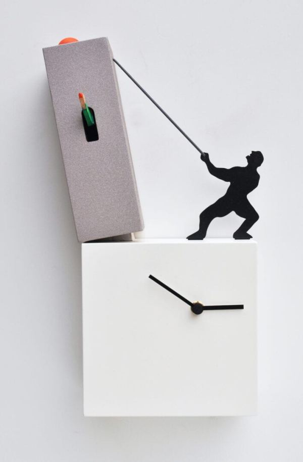 Lo Tengo in white and grey viewed from the front, showing a toppling grey tower being pulled back by a black figure who stands on top of a white block which forms the lower part of the clock