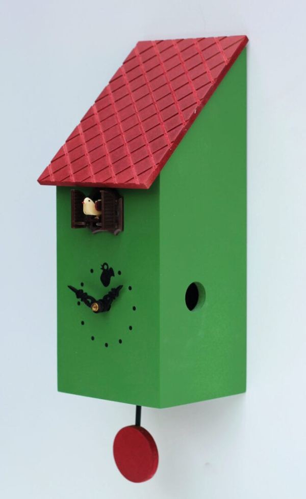 Viewed from the right, the portofino cuckoo clock in green with a burgundy roof and pendulum and a black clock face