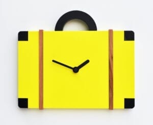 An unusual cuckoo clock in the form of a suitace, presented in sulphur yellow with black detail.