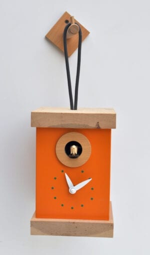 The Titti Cuckoo Clock in Orange-Yellow in the form of a hanging lantern, with white hands and a hanging loop.