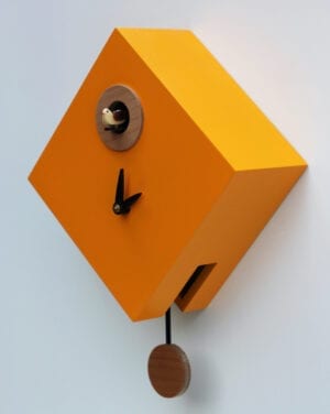 The Rombino Cuckoo Clock in melon yellow, with black hands and cuckoo to the top of the clock