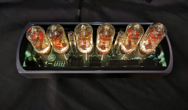 Viewed from above, Genesis CS showing yellow lit nixie tubes and smoked glass top to internal workings