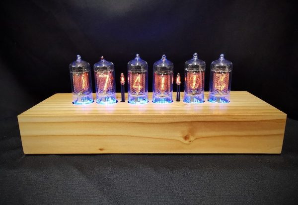 Cadence clock in cedar, showing graining of the wood, which is individual to each clock, and back lit nixie tubes