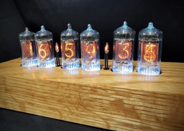 Closeup of Cadence oak showing blue back lit Nixie tubes and the individual graining of the solid oak frame