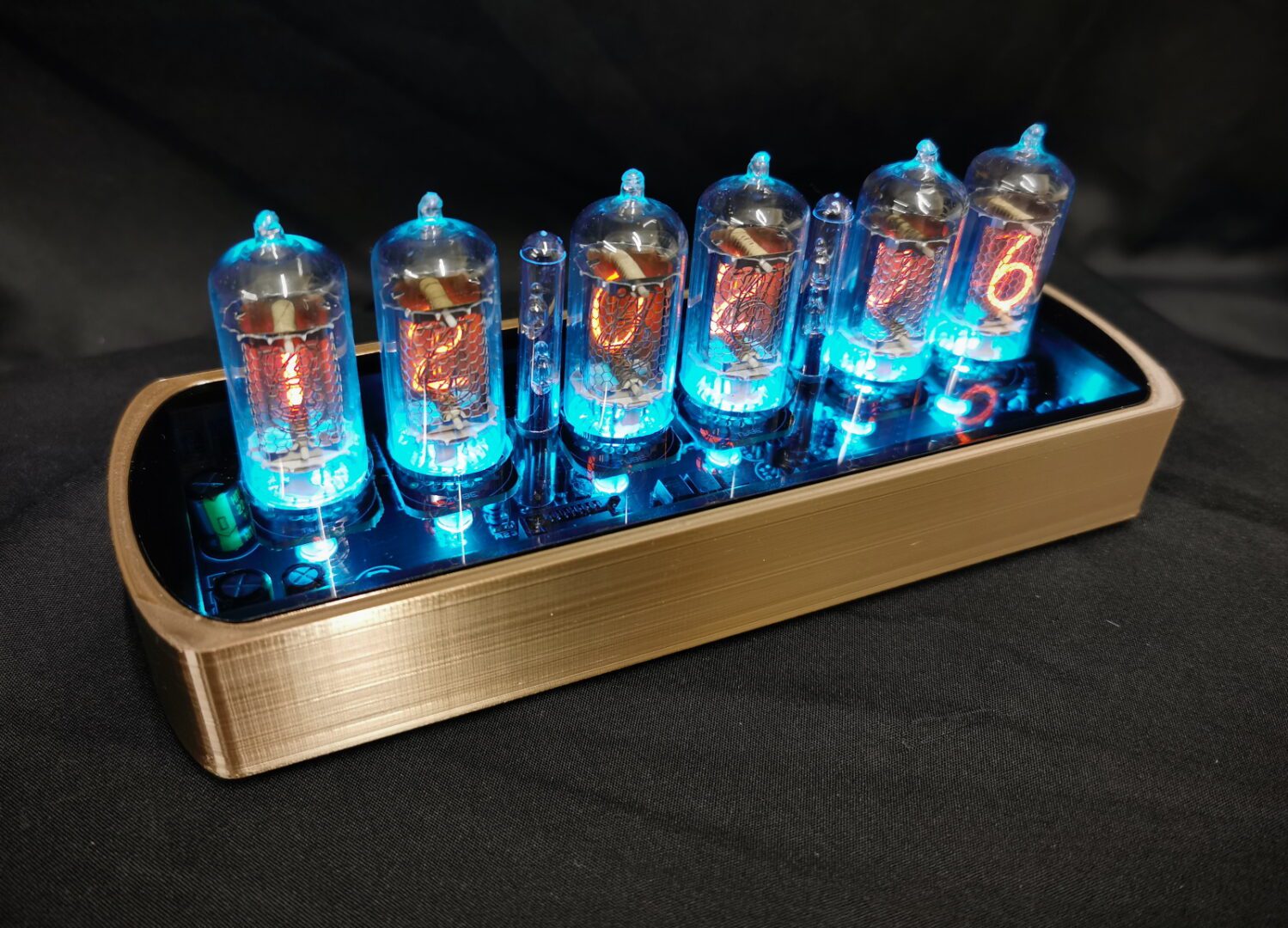 Genesis GS nixie tube clock in gold 3D print with acrylic lid for viewing internal workings, blue backlit tubes