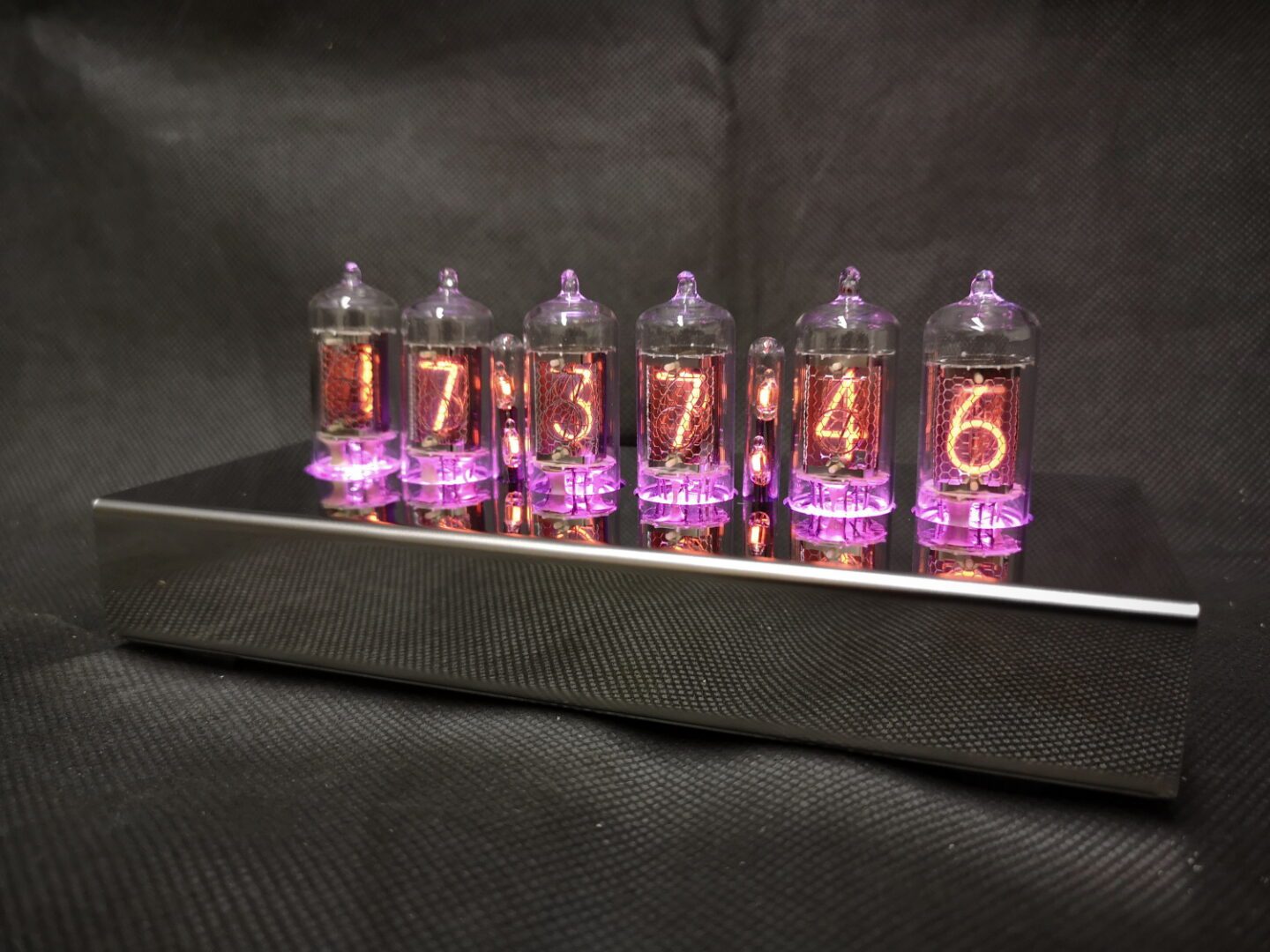 T-1000 Nixie clock with pink lighting theme, showing 6 nixie tubes in a stainless steel frame