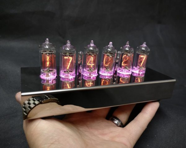 T-1000 Nixie clock held in a man's hand to show size