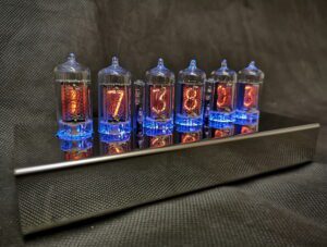 T1000 Nixie clock showing blue lighting theme, with 6 nixie tubes used for time and date, in a stainless steel case