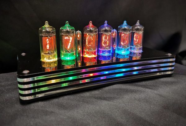 Humbug Nixie tube clock with a layered acrylic case which pick up the colours of the tubes to make a colourful and ever changing display. the clock has 6 nixie tubes which can be programmed to change colour depending on the number displayed on the clock