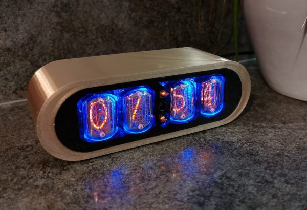 Closeup of gold POD clock showing case detail
