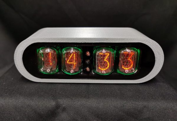 POD clock with 3D printed silver case, showing orange numerals within the nixie tube