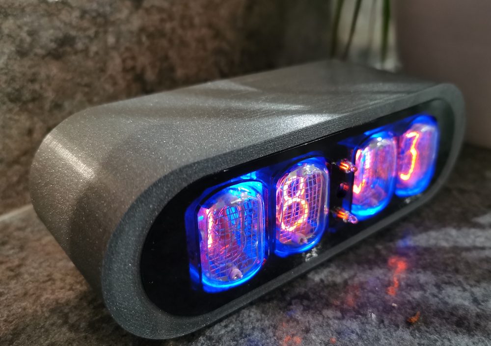 Anthracite POD clock viewed from the left, showing 3D printing detail and nixie tubes