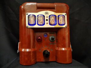 An upcycled geiger counter made into a nixie clock, in bakelite