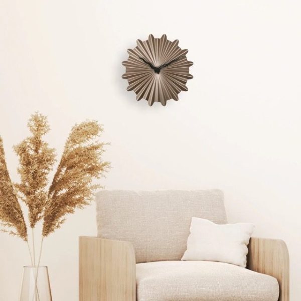 Sunny wall clock in a room setting with pampas grasses and cream coloured soft chair.